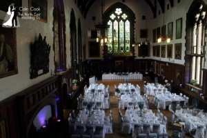 A daytime photo of Durham Castle ready for a wedding. Moodlighting in Purple, Master of Ceremonies set up and music ready to go.